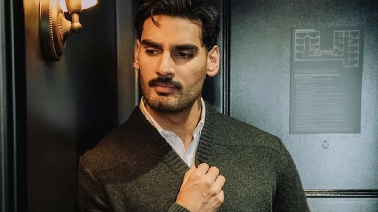 He favours refined layers like charcoal cardigans over crisp white shirts with tailored trousers for events, exuding understated elegance. 