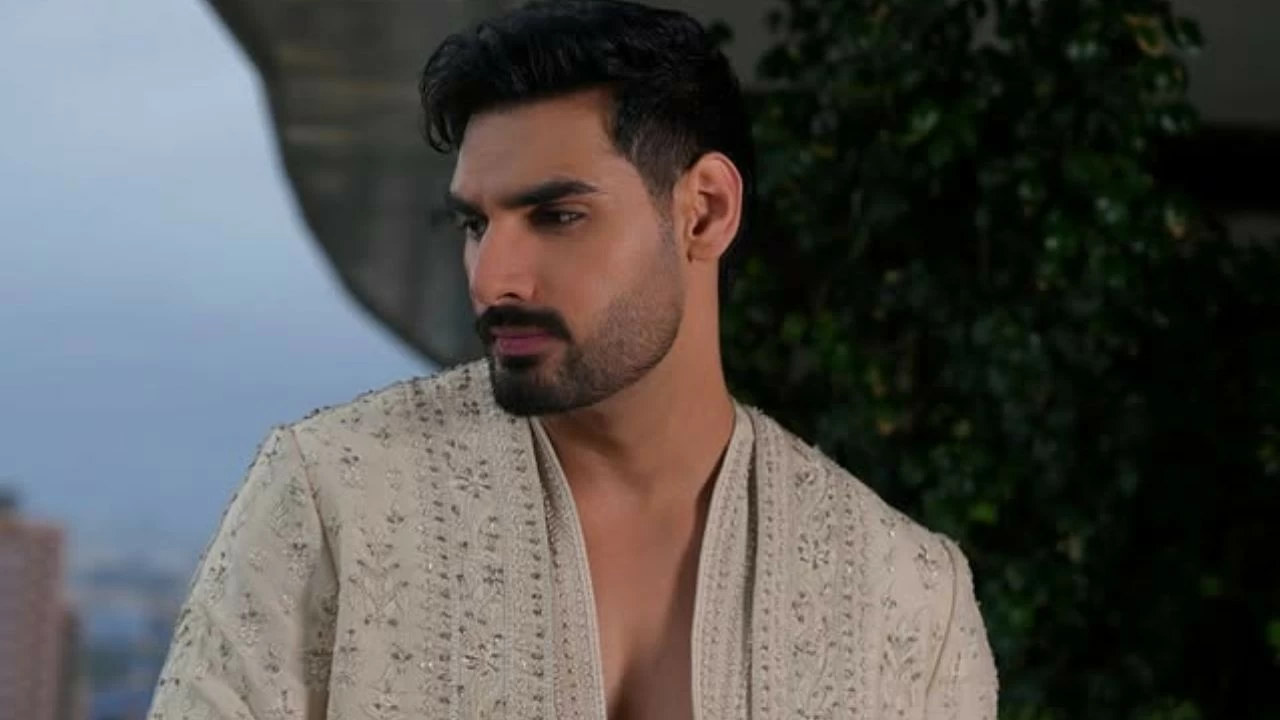 Ahaan is wearing a sheer white Kurta in fine net fabric layered with an embroidered sherwani jacket, a perfect blend of Indo-Western look.