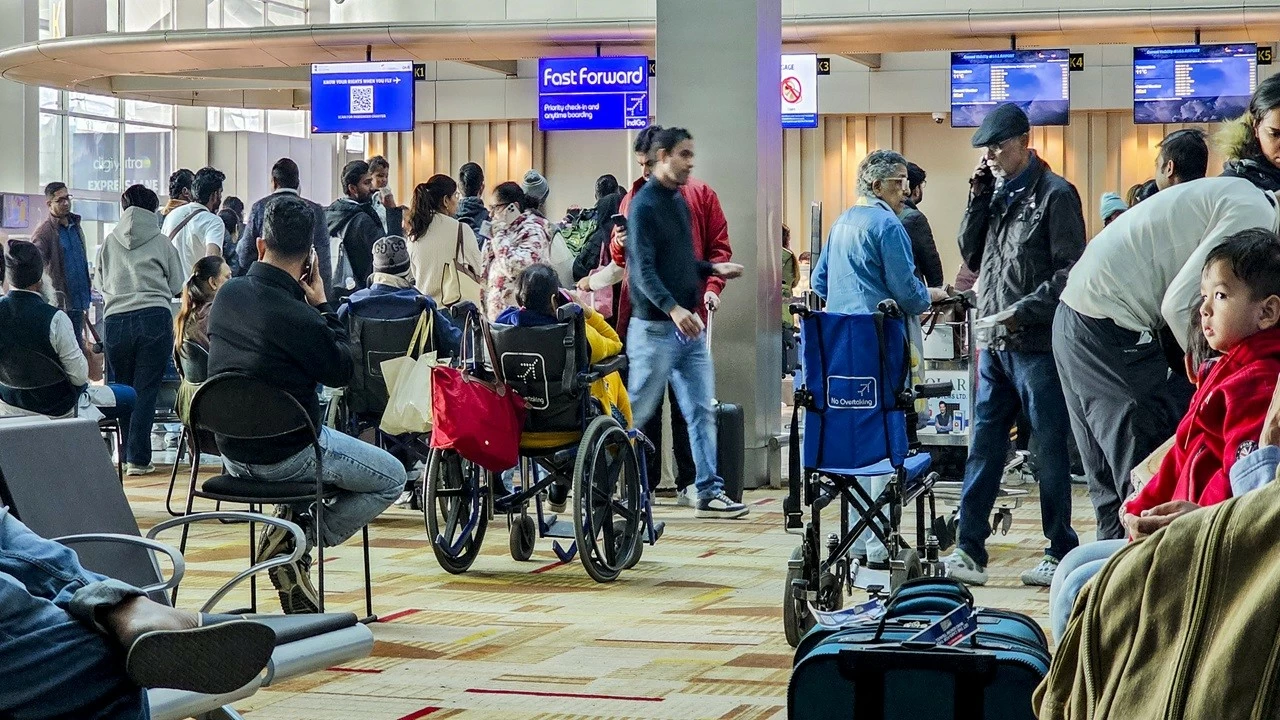 Passengers wait at the counters at the IGI Airport in New Delhi on Friday.