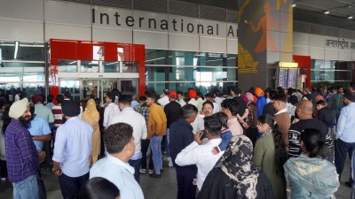  People wait outside the arrivals exit at the Indira Gandhi International (IGI) Airport, in New Delhi, in New Delhi, Friday 