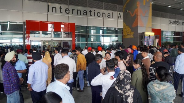  People wait outside the arrivals exit at the Indira Gandhi International (IGI) Airport, in New Delhi, in New Delhi, Friday 