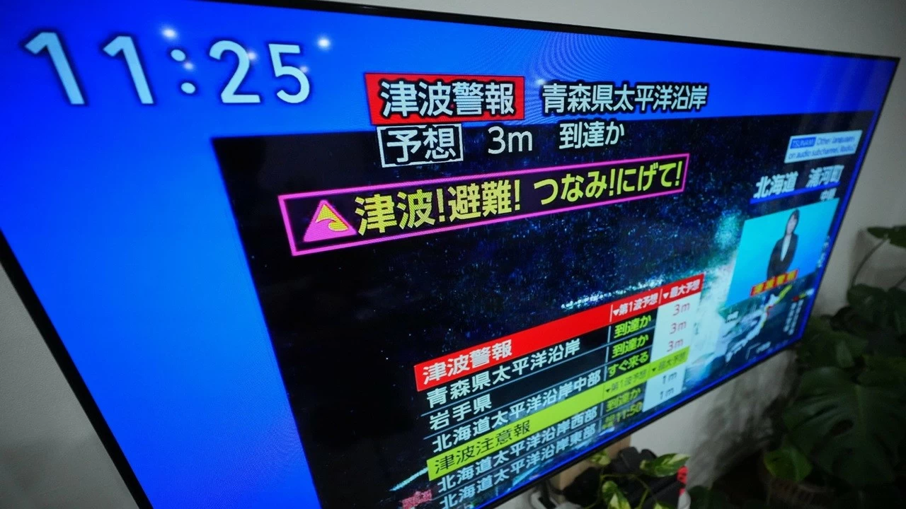 A tsunami warning is displayed on a television in Yokohama, near Tokyo on Monday.