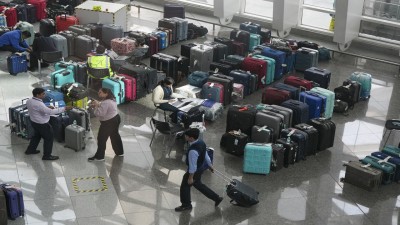 Luggage of passengers piled up at the Indira Gandhi International Airport amid IndiGo flight disruptions in New Delhi on Monday.
