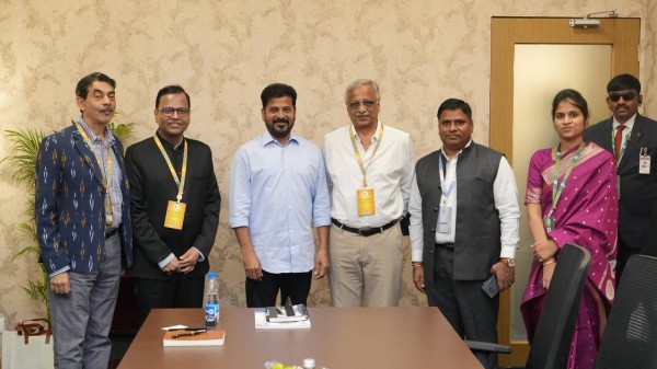 Telangana CM Revanth Reddy signs MoUs at Global Summit. 