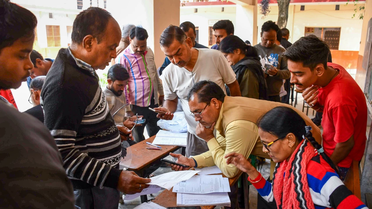 BLOs check and collect enumeration forms as voters arrive to submit them for the SIR of electoral rolls. (Representative image: PTI)
