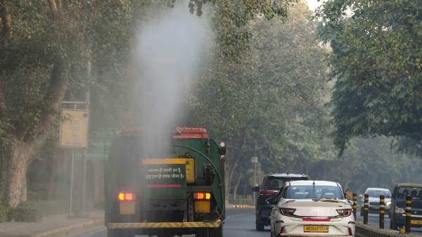 An anti-smog gun being used to spray water droplets to curb air pollution, in New Delhi