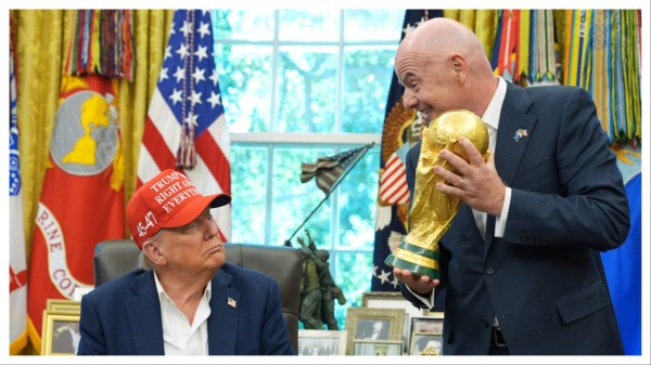 FIFA President Gianni Infantino, right, prepares to hand the FIFA World Cup trophy to US President Donald Trump on Aug. 22.
