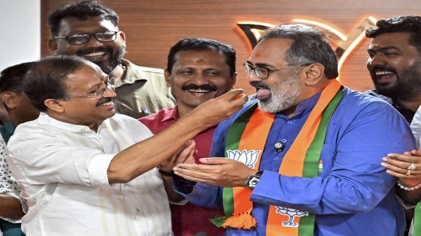 Kerala BJP President Rajeev Chandrasekhar, front right, being offered sweets by senior party leader V Muraleedharan, left, during the celebration of the party-led NDA's victory from Trivandrum corporation in Kerala's local body elections on Saturday.