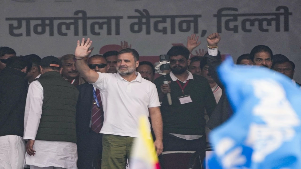 Rahul Gandhi waves to the gathering during the Congress rally at Ramlila Maidan in New Delhi on Sunday.