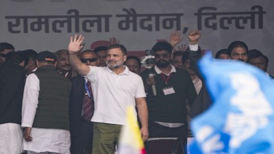 Rahul Gandhi waves to the gathering during the Congress rally at Ramlila Maidan in New Delhi on Sunday.