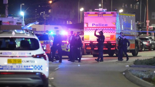 	
Police cordon off an area at Bondi Beach after a reported shooting in Sydney