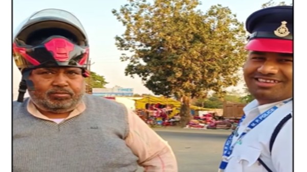 The helmet offered by the policeman doesn't fit the biker's head. (Photo: Instagram)