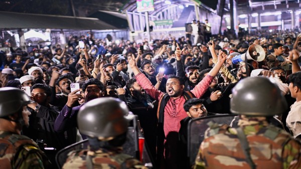 Protesters shout slogans in front of the premises of the Prothom Alo daily newspaper after news reached the country from Singapore of the death of a prominent activist Sharif Osman Hadi, in Dhaka, Bangladesh, on Friday, Dec. 19, 2025. (AP/PTI)