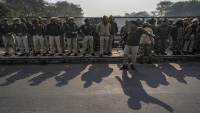 Police personnel stand guard near the Bangladesh High Commission in view of a protest against the alleged attacks on Hindus in Bangladesh, in New Delhi on Tuesday. 