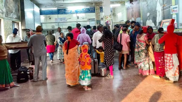Passengers queue at Anakapalle Railway station after the fire accident. 