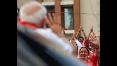 A woman breaks down in tears of happiness upon spotting PM Modi during a roadshow in Ahmedabad. (Photo credit: narendramodi.in)