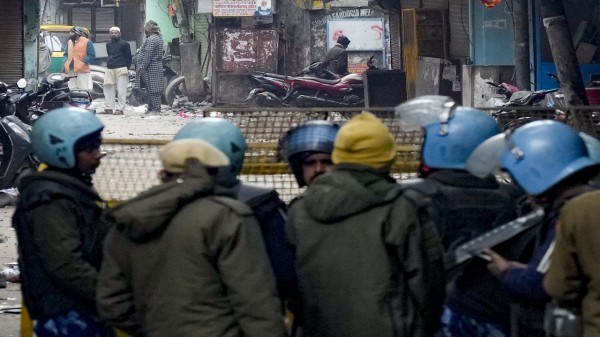 Police and security personnel stand guard near the Syed Faiz Elahi mosque after the demolition at Turkman Gate area, in New Delhi. (PTI Photo/Shahbaz Khan)