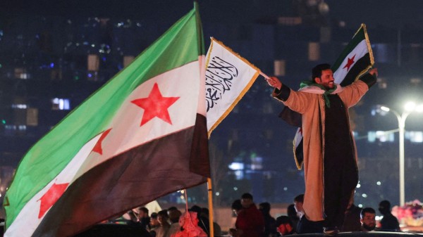 People celebrate after the SDF has signed a deal agreeing to integrate into Syria's new state institutions, in Damascus
