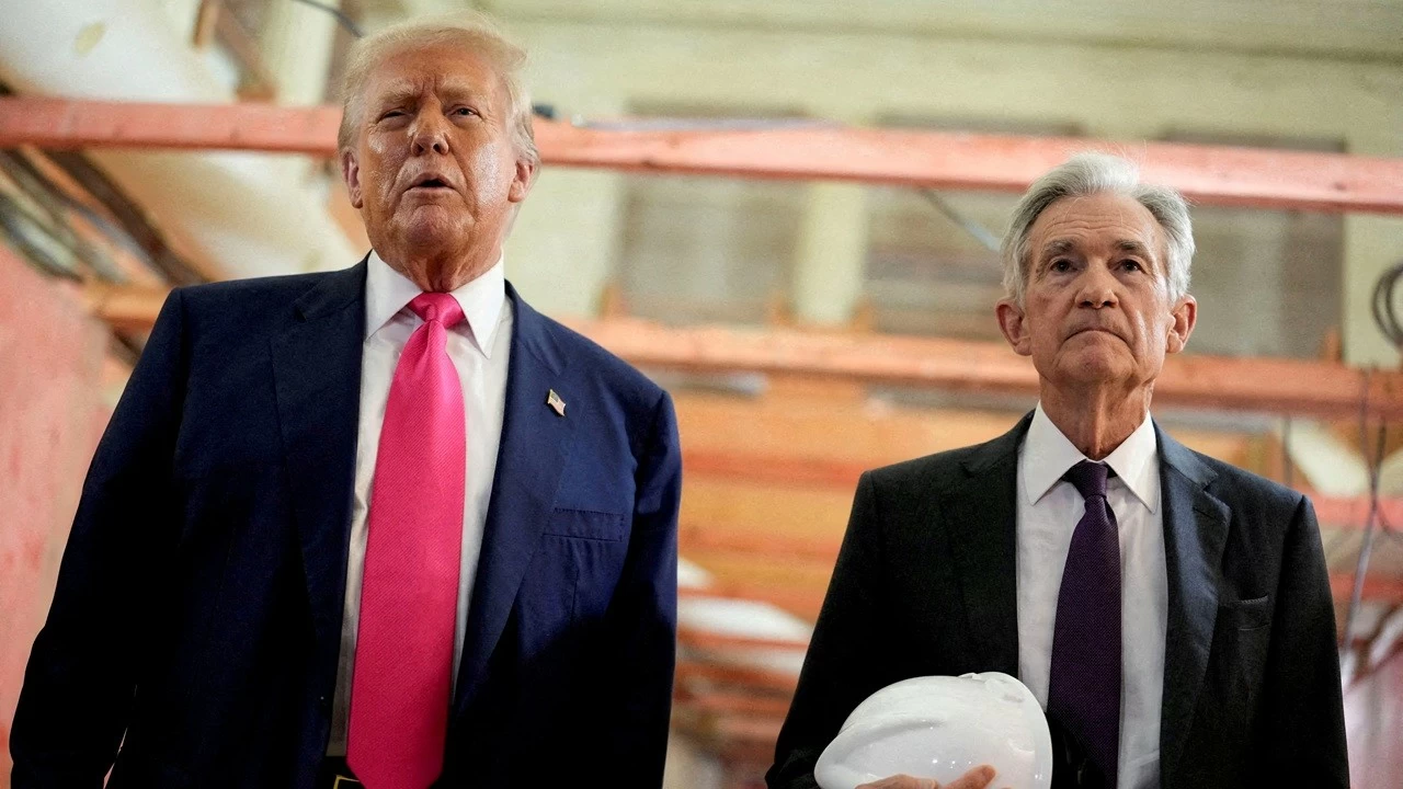 US President Donald Trump and Federal Reserve Chair Jerome Powell speak during a tour of the Federal Reserve Board building.

