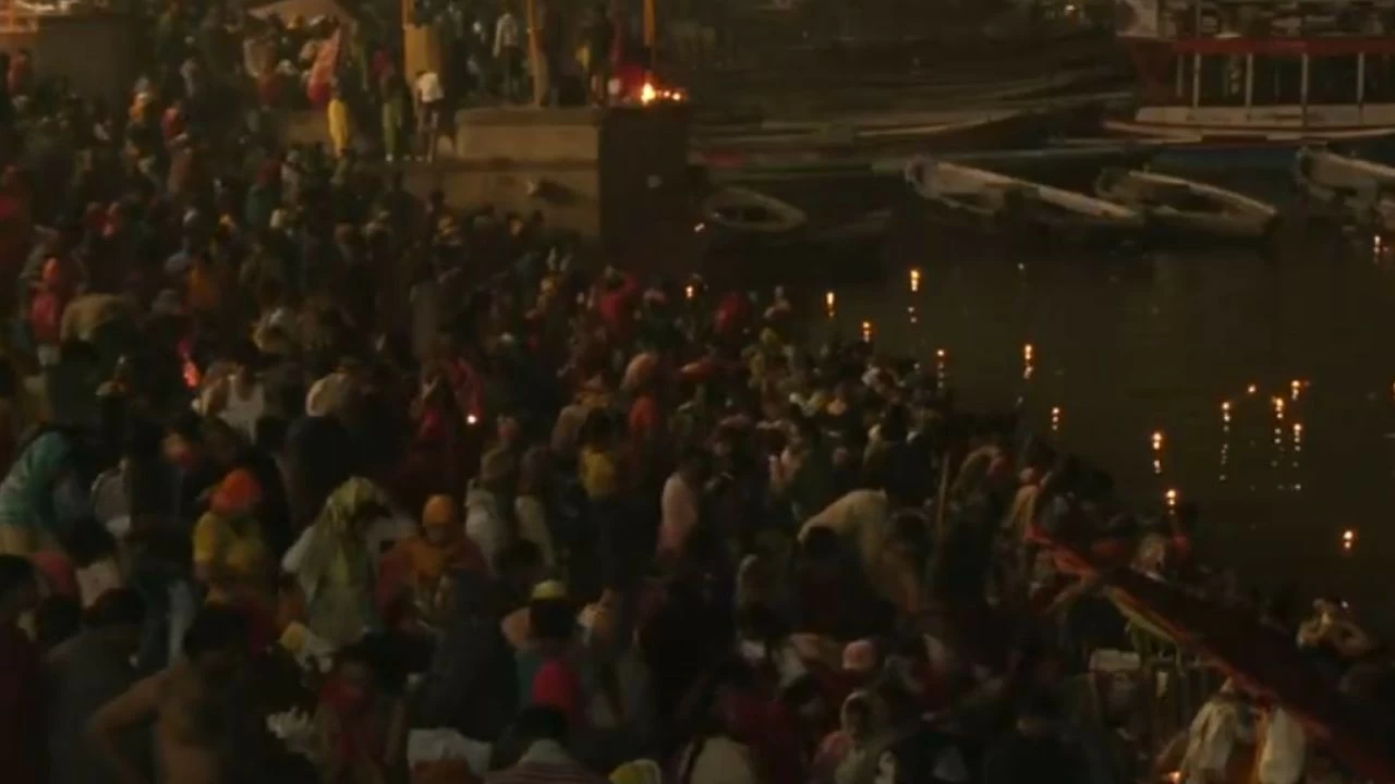 Devotees take a holy dip in the Ganga river in Varanasi on the occasion of Makar Sankranti
