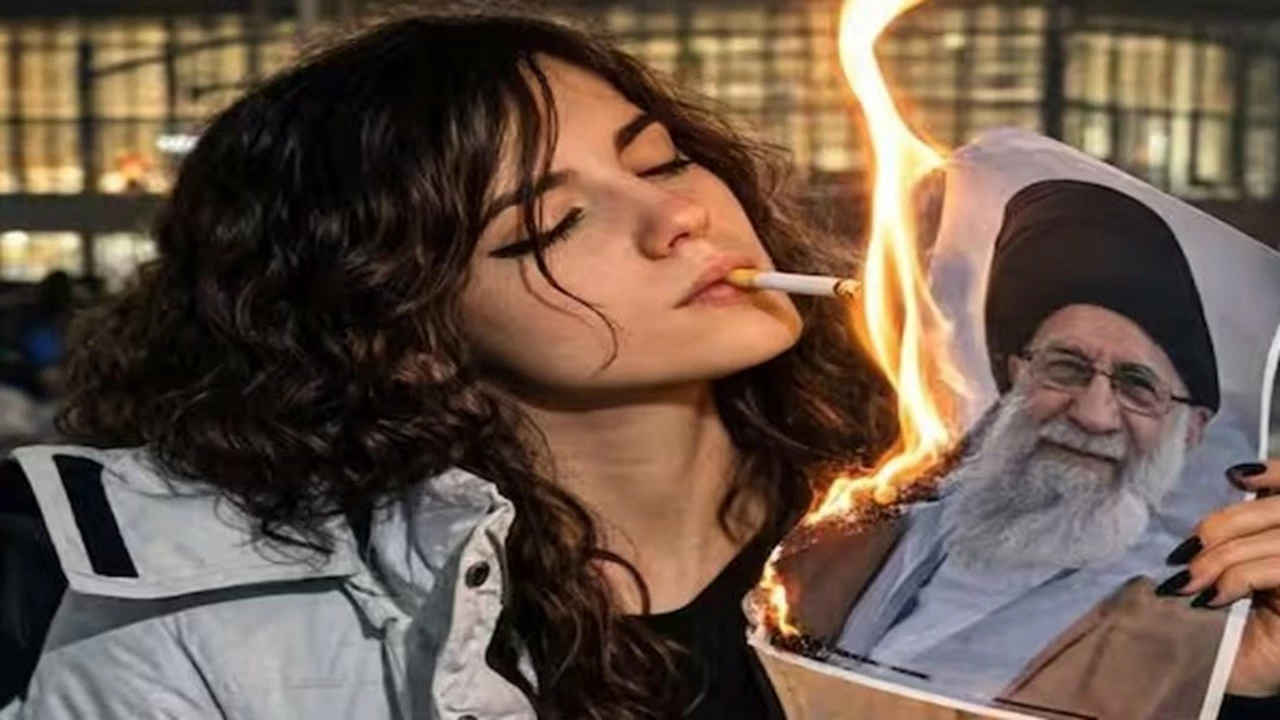 Pictures of young women lighting cigarettes with a burning picture of Iran’s Supreme Leader Ayatollah Ali Khamenei have become the symbol of the current protests in Iran. 