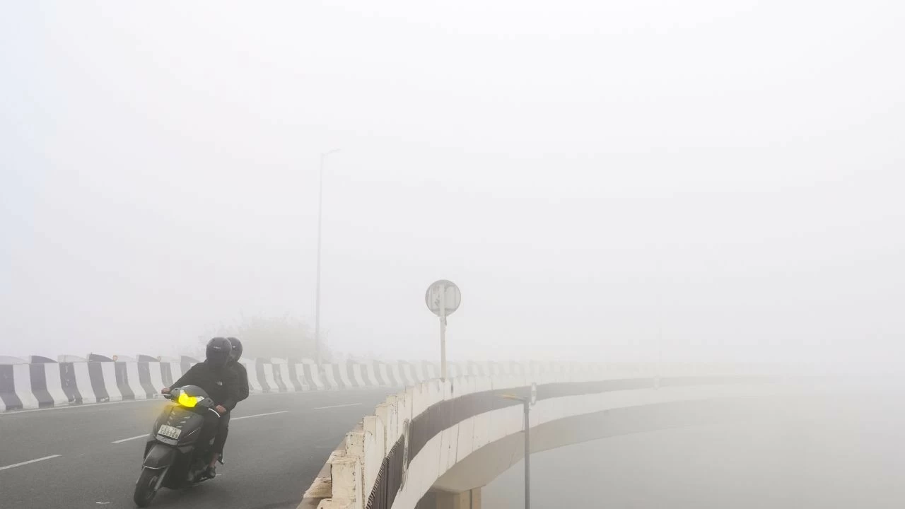  Commuters make their way through dense fog during a cold winter morning, in New Delhi on January 17, 2026 