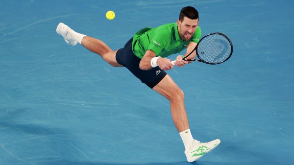 Novak Djokovic plays a backhand against Pedro Martinez during the Men's Singles First Round match of the 2026 Australian Open at Melbourne Park.