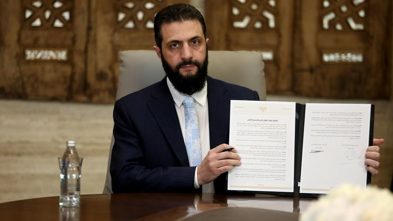Syrian President Ahmed Al-Sharaa speaks to media as he signs a ceasefire agreement with the Kurdish-led Syrian Democratic Forces (SDF) on January 18, 2026, in Damascus, Syria.

