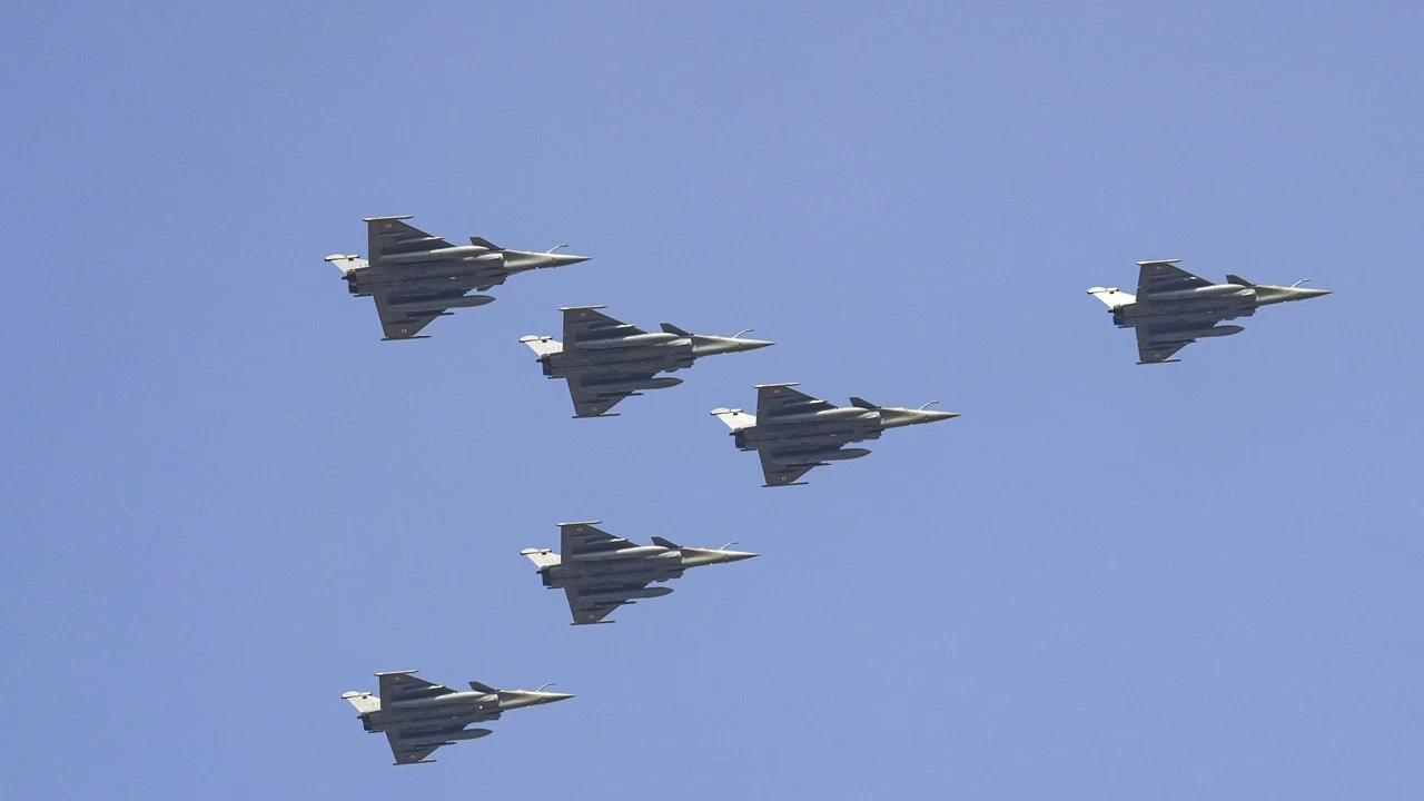 IAF's Rafale aircrafts perform a flypast in Vajrang formation over the Kartavya Path during the 77th Republic Day Parade in New Delhi on Monday.